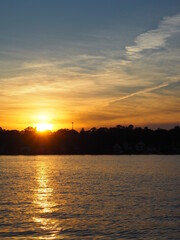 Naklejka premium Lake Sunset Reflecting Across the W - Outdoor Recreationater