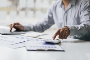 Accounting businessman working on laptop and analyzing real estate investment data, Financial and...
