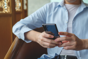 Close up of a man using mobile smart phone.