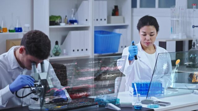 Modern lab technicians working on experiment, inventing medicine for disease