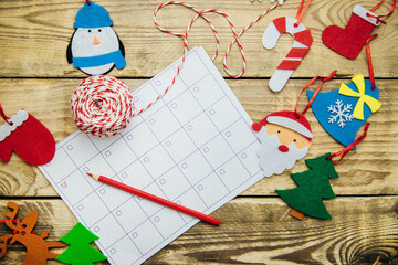 Christmas composition with a glider or calendar .Flat felt handmade toys. Red mittens, felt Santa,...