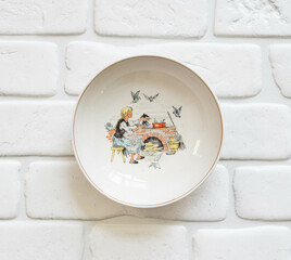 Vintage porcelain plate for children with a scene from the story Cinderella
