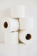 Rolls of white toilet paper on a white background