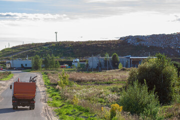 Fototapeta na wymiar Garbage truck on the road to a dump area.