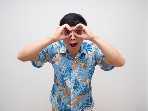Cheerful man beach shirt gesture binoculars his hand isolated