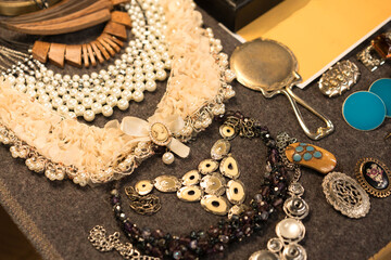 Antiques at flea market or seasonal festival - vintage jewelry with pearls, cameo necklace and...