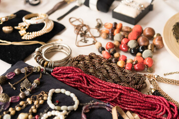 Antiques at flea market or garage sale - vintage jewelry, retro beads necklace and other vintage things. Collectibles memorabilia concept. Selective focus
