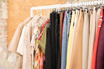 Women's vintage clothes on hangers - second hand clothes store or thrift shop. Clothing rental service. Clothes rail with copy space for text. Selective focus