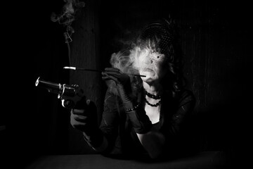 smoking woman with gun dramatic portrait from gangster era - obrazy, fototapety, plakaty