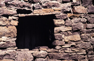 old stone wall with window