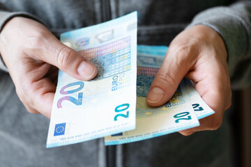 Euro money twenty bills closeup in white female hands