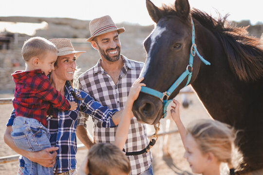 Happy family enjoy day at horse ranch outdoor