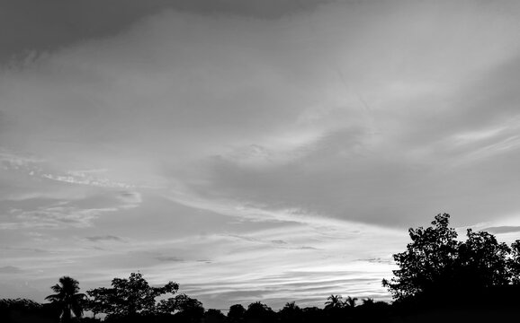Dramatic monsoon cloud formation in the sky during sunset black and white photo