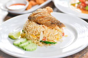 stir fried rice or fried rice with fried fish topping , fish and rice