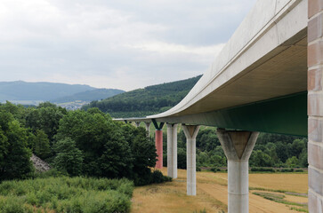 Fototapeta na wymiar Concrete bridge on big pillars in mountain landscape near Olsberg, Sauerland, Germany