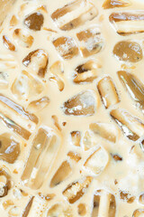 Cold coffee and ice cubes,Coffee texture and macro ice cubes,Close-up of Cold latte drink with ice cubes, 