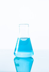 blue science experiment flask on white background