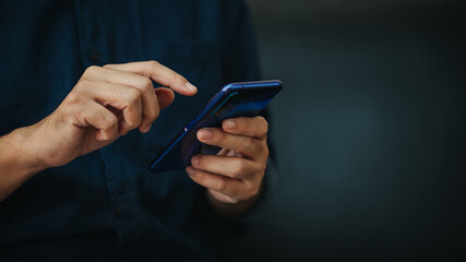 Young businessman working at the office for investment analyzing company financial report balance with smart phone. Concept for young entrepreneur and business start up.