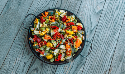  Grilled vegetables in a pan on a wooden table at summer. Vegan, vegetarian, seasonal, healthy eating diet concept. Flat lay