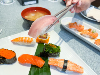 Sushi set of nigiri and maki rolls served on dish. Japanese food.