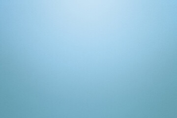 Light blue or turquoise textured paper background with light effect. Copy space.