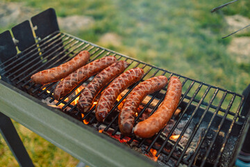 Grilling sausages on barbecue grill. Selective focus. 