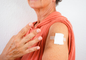 70-year-old Caucasian woman after receiving the fourth booster dose of the covid-19 coronavirus vaccine. Concept of protection, responsibility and healthcare