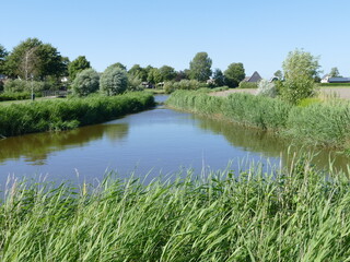 Fototapeta na wymiar Picturesque landscape of waterways and greenery in Tuitjenhorn, North Holland, The Netherlands