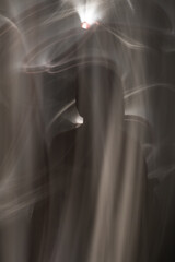 Abstract human silhouette in light trails of light painting with white light beams. Portrait in the...