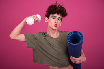 Fitness and healthy lifestyle. Sporty funny drag queen. Pink background.	