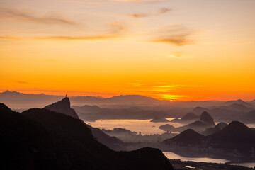 Beautiful orange sunrise view to city, ocean, sky and mountains