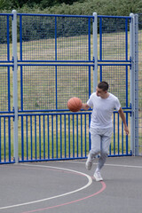 A Nineteen Year Old Teenage Boy Playing Basketball