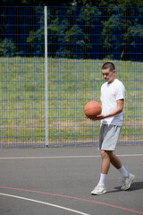 Obraz premium A Nineteen Year Old Teenage Boy Playing Basketball