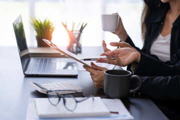 Analysis, Discussion, Asian women economists and marketers use a tablet computers to plan investments and finances to prevent risks and losses for the company, Negotiation