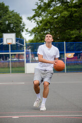 Obraz premium A Nineteen Year Old Teenage Boy Playing Basketball