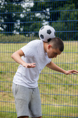 A Nineteen Year Old Teenage Boy Playing Football in A Public Park