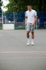 Obraz premium A Nineteen Year Old Teenage Boy Playing Football in A Public Park