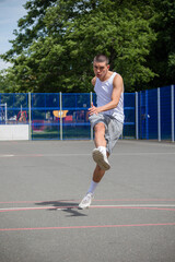 Obraz premium A Nineteen Year Old Teenage Boy Playing Football in A Public Park