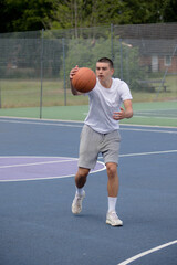 Obraz premium A Nineteen Year Old Teenage Boy Playing Basketball