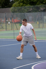 Obraz premium A Nineteen Year Old Teenage Boy Playing Basketball