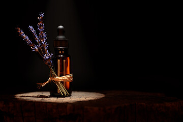 Bottle of lavender essential oil with fresh lavender twigs. Copy space. Aromatherapy concept....