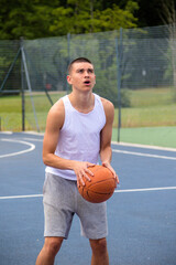 Fototapeta premium A Nineteen Year Old Teenage Boy Playing Basketball