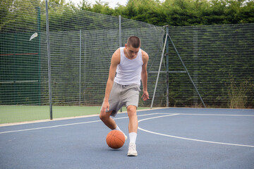 Obraz premium A Nineteen Year Old Teenage Boy Playing Basketball