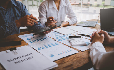 Financial analyst analysis business financial report on digital tablet during discussion at meeting of corporate showing the results of their successful teamwork, business meeting concept, Marketing