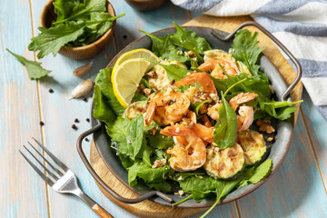 Healthy food concept. Diet summer salad plate. Shrimps salad with arugula, grilled zucchini and walnut.