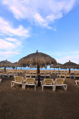 Beach Cabana with chairs and thatch straw umbrella