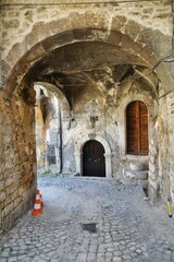 Obraz premium A narrow street between the old stone houses of Campo di Giove, a medieval village in the Abruzzo region of Italy.