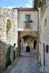A narrow street between the old stone houses of Campo di Giove, a medieval village in the Abruzzo region of Italy.
