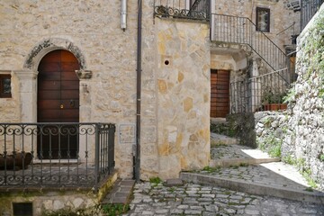 Fototapeta na wymiar A narrow street between the old stone houses of Campo di Giove, a medieval village in the Abruzzo region of Italy.