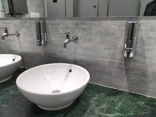 Interior of bathroom with sink basin faucet. Open chrome faucet washbasin. Modern design of bathroom. 